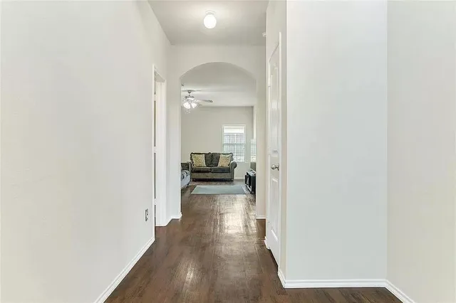 a view of a hallway with a wooden floor