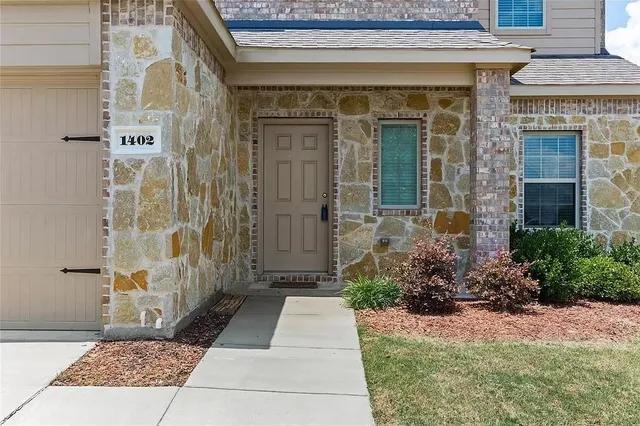 a view of a brick house with a large windows