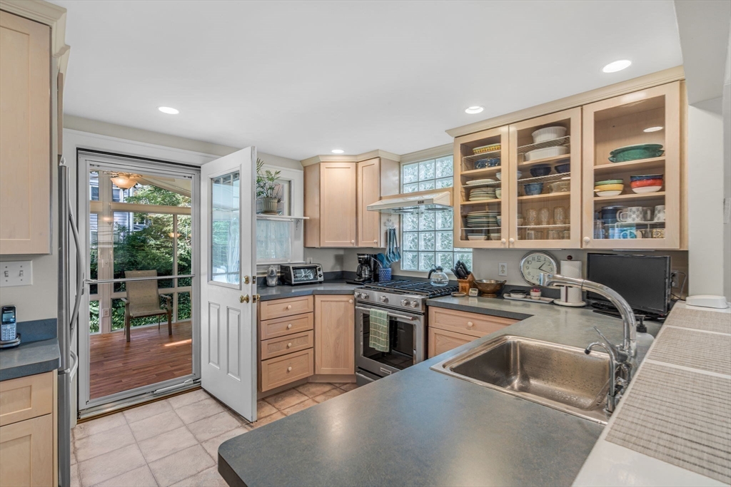 10 Stevens Terrace Arlington, MA 02476 - Photo 12 of 31 a kitchen with sink a stove and cabinets