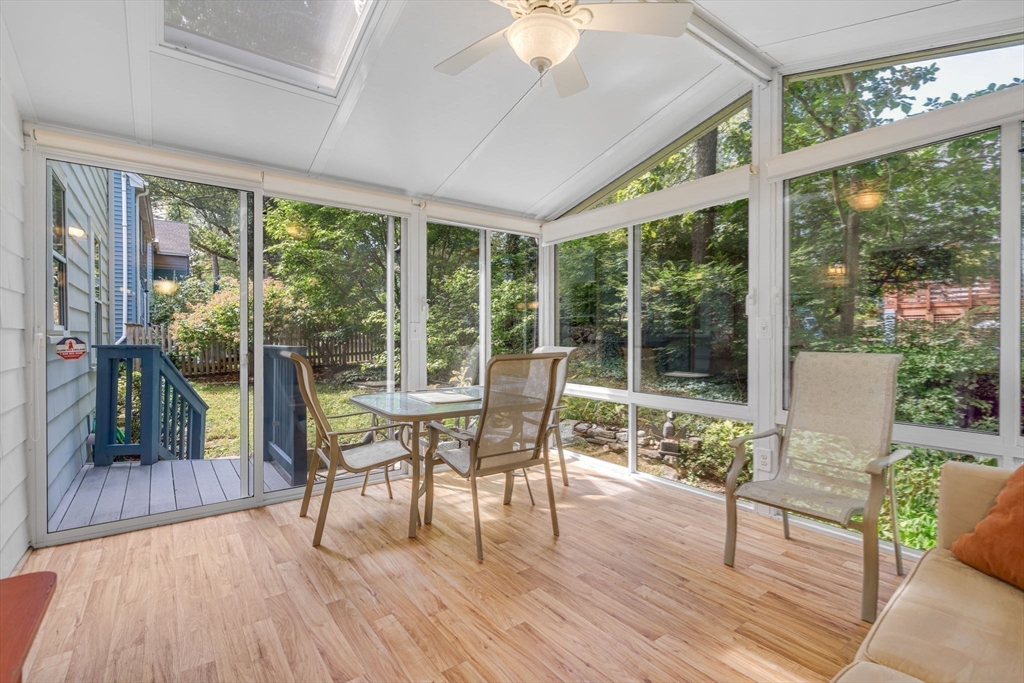 10 Stevens Terrace Arlington, MA 02476 - Photo 13 of 31 a dining room with wooden floor and a floor to ceiling window
