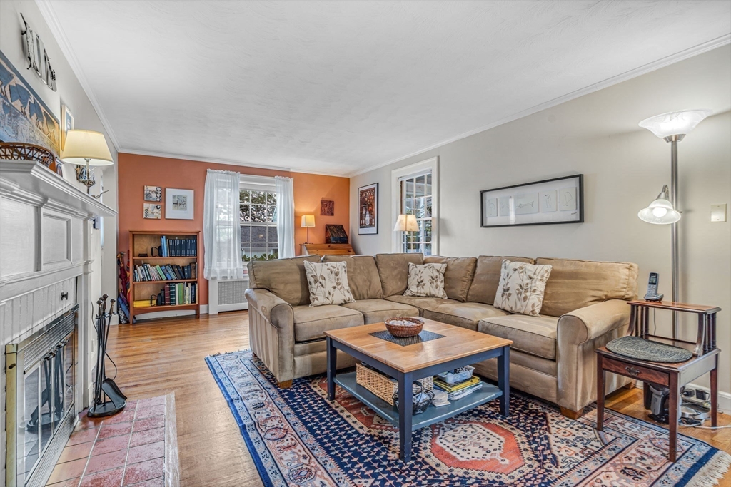 10 Stevens Terrace Arlington, MA 02476 - Photo 2 of 31 a living room with furniture and a fireplace