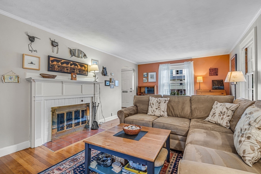 10 Stevens Terrace Arlington, MA 02476 - Photo 3 of 31 a living room with furniture and a fireplace