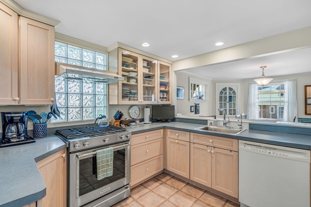 10 Stevens Terrace Arlington, MA 02476 - Photo 9 of 31 a kitchen with stainless steel appliances granite countertop a sink stove and cabinets