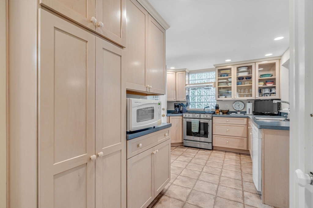 10 Stevens Terrace Arlington, MA 02476 - Photo 10 of 31 a kitchen with granite countertop white cabinets and white appliances