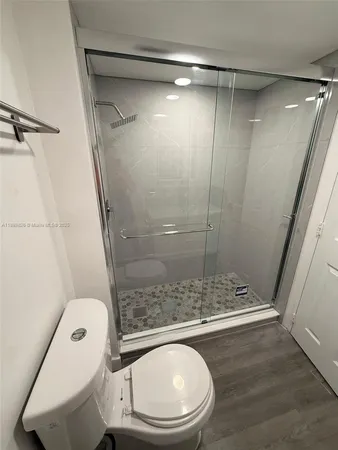 a bathroom with a toilet and a shower