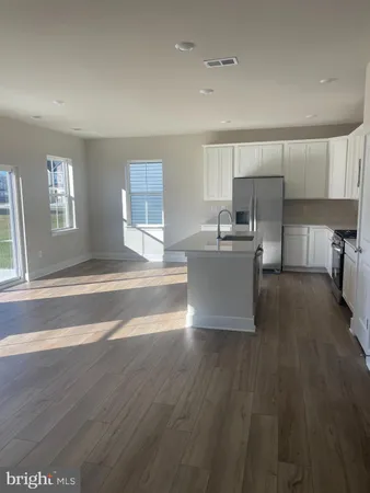 a room with a sink wooden floor and view living room