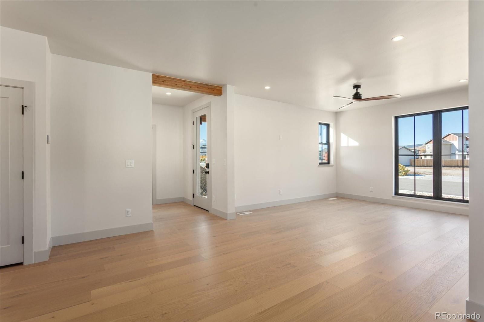 125 Confluence Road Salida, CO 81201 - Photo 17 of 48 an empty room with wooden floor and windows