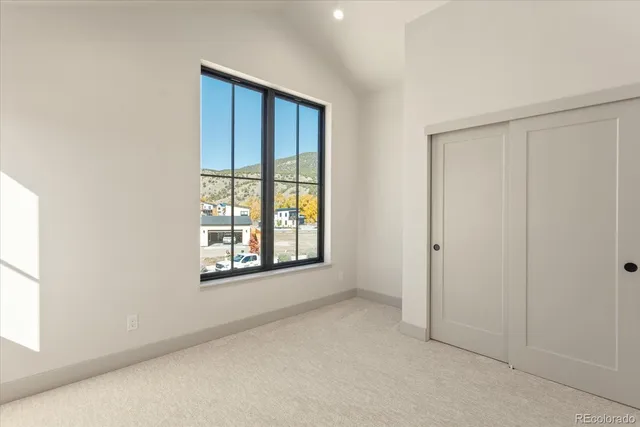 an empty room with windows and closet