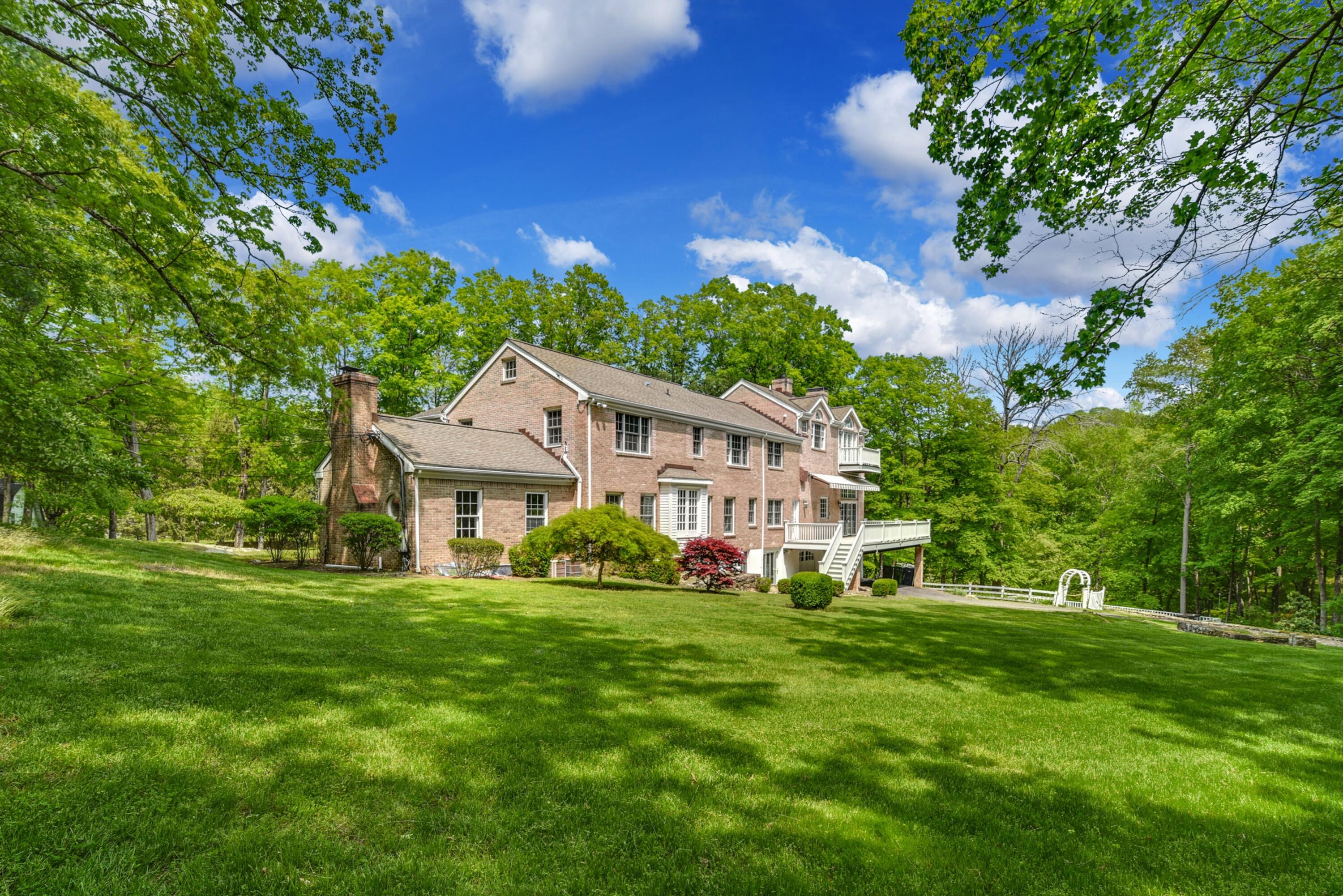 507 Trinity Pass Road New Canaan, CT 06840 - Photo 19 of 23 a front view of a house with a yard