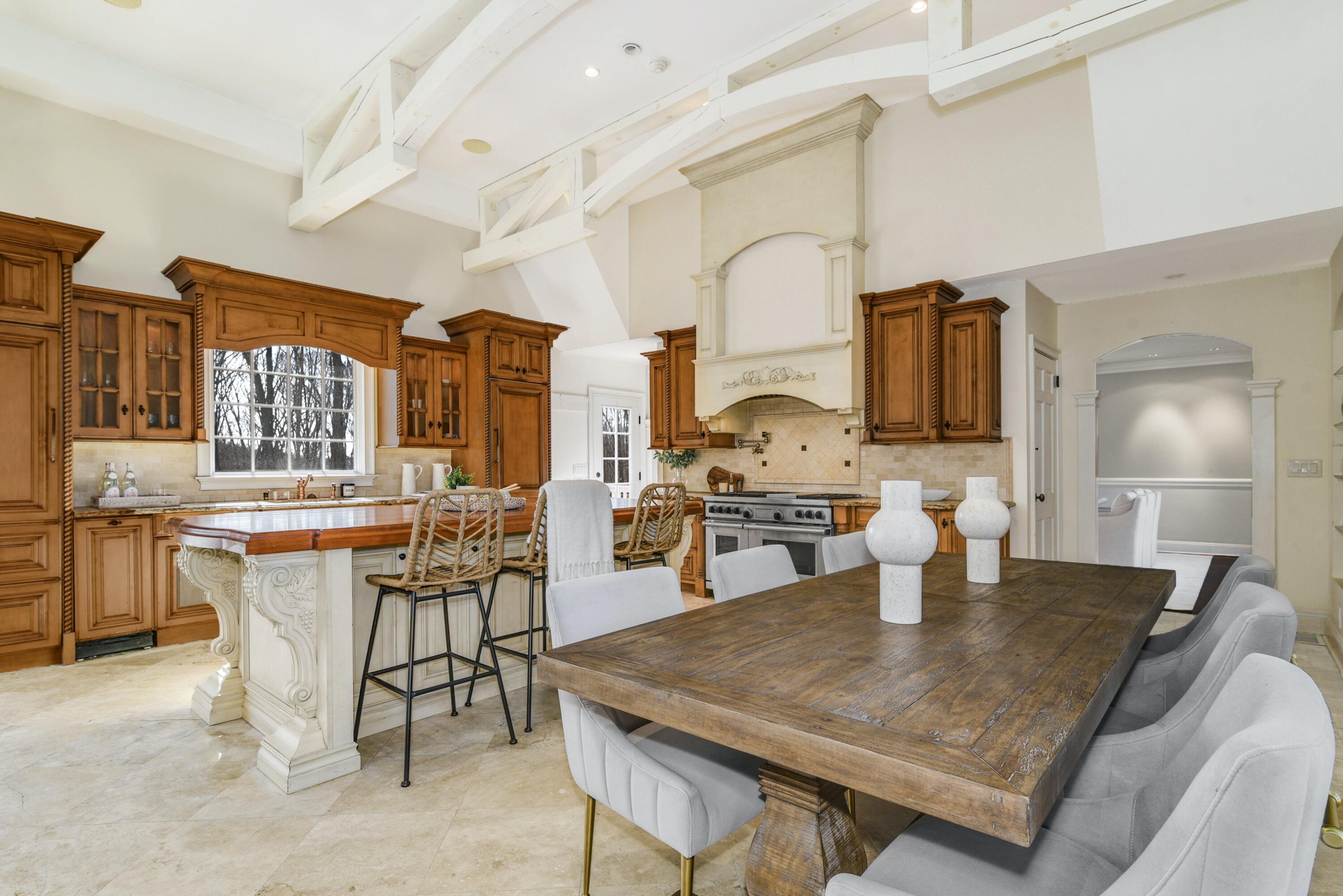 507 Trinity Pass Road New Canaan, CT 06840 - Photo 7 of 23 a kitchen with a table chairs and a stove