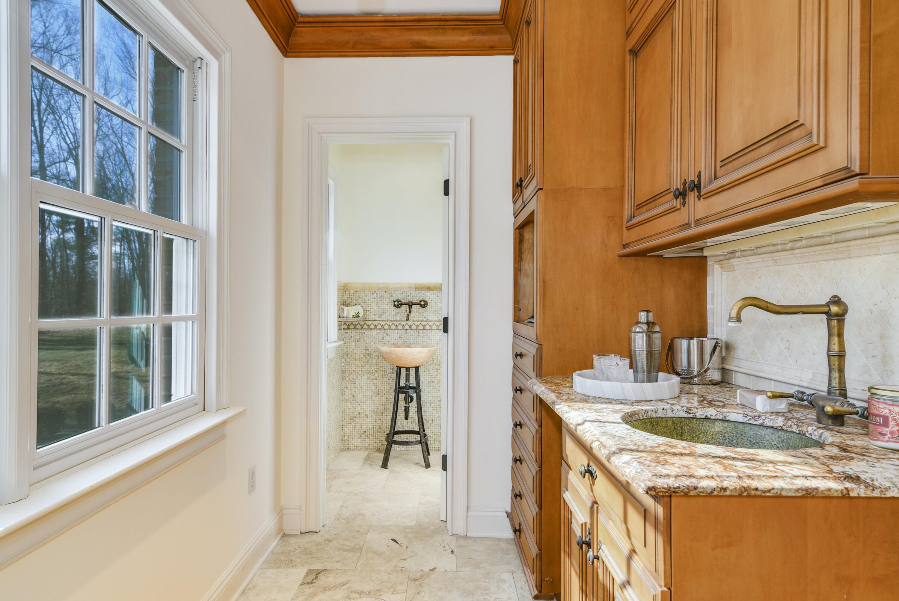 507 Trinity Pass Road New Canaan, CT 06840 - Photo 9 of 23 a bathroom with a granite countertop sink and a mirror