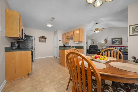 a view of a dining room with furniture and a chandelier