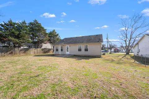 a front view of a house with a yard and trees