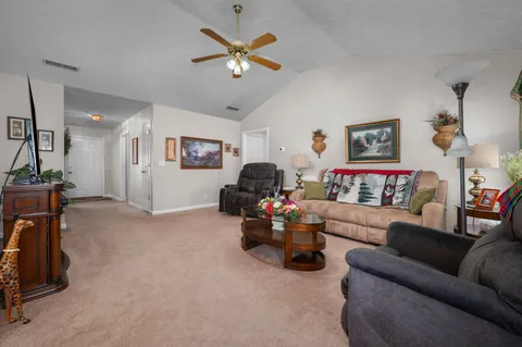 a living room with furniture and a chandelier