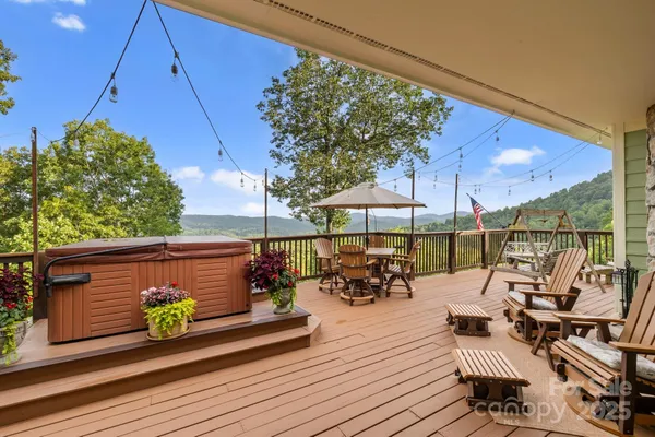 a view of sitting area with chairs on wooden deck