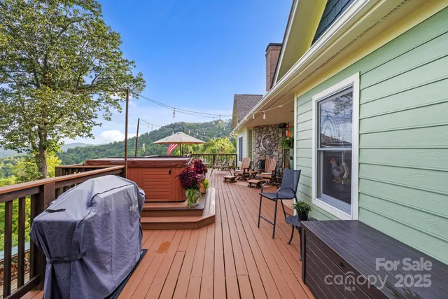 a view of deck with furniture and trees