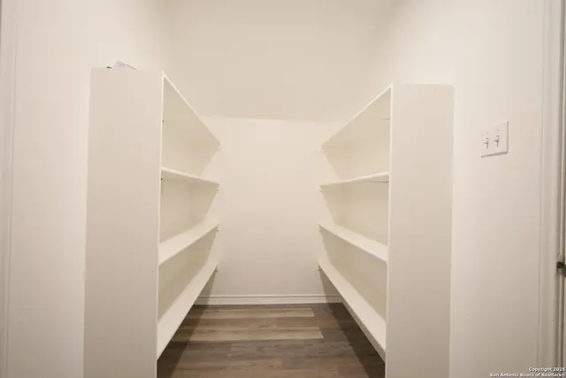a view of staircase with white walls and white door