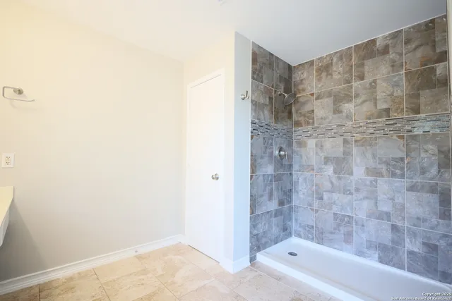 a bathroom with a bathtub and shower