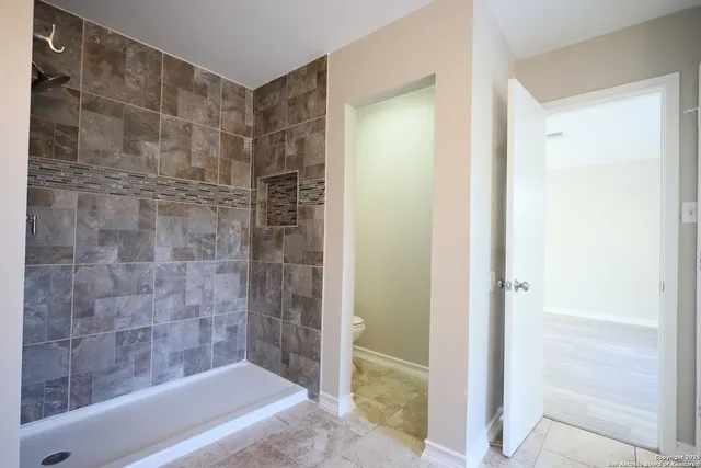 a bathroom with a bathtub and a shower