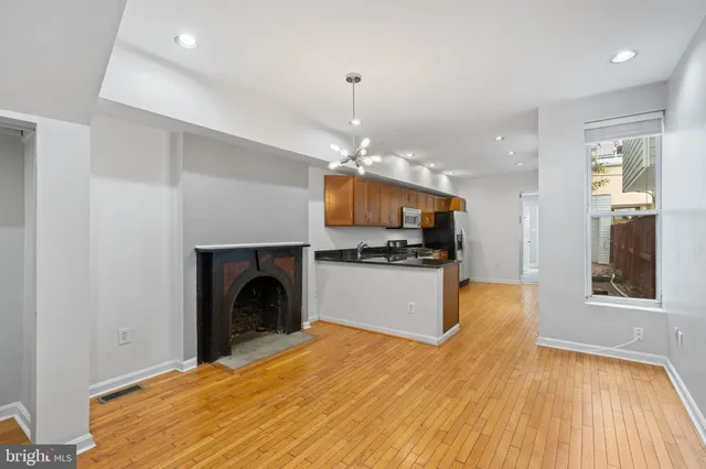 a view of a kitchen with microwave and cabinets