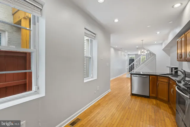 a view of a kitchen with a sink and a window