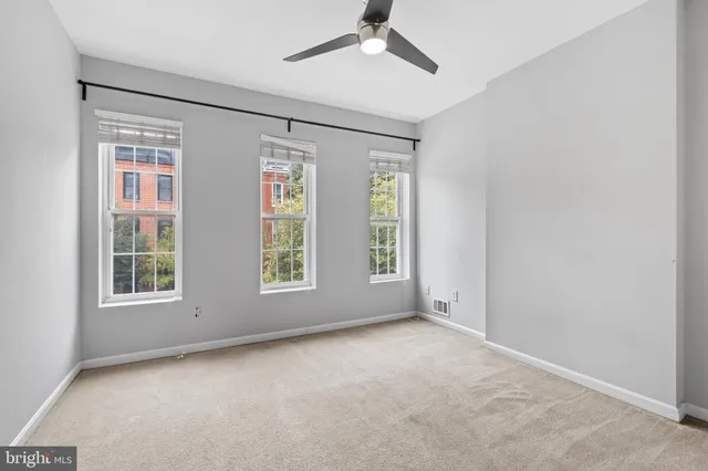 an empty room with windows and closet