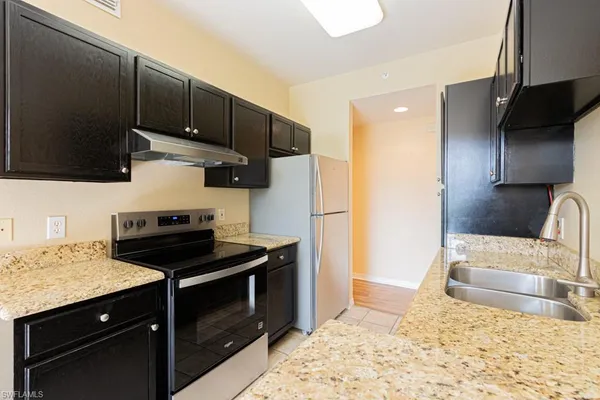 a kitchen with a sink appliances and cabinets