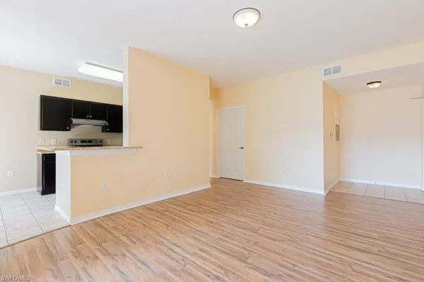a view of a room with wooden floor and bench