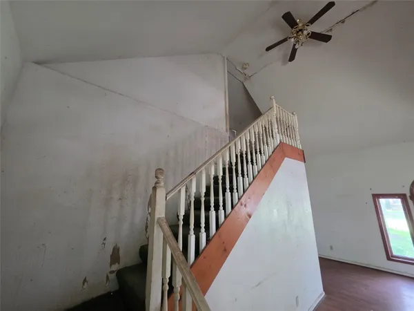 a view of a livingroom with furniture and staircase
