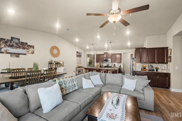 a view of a living room kitchen and a chandelier