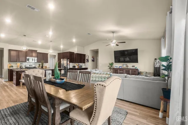 a view of a dining room with furniture and a flat screen tv