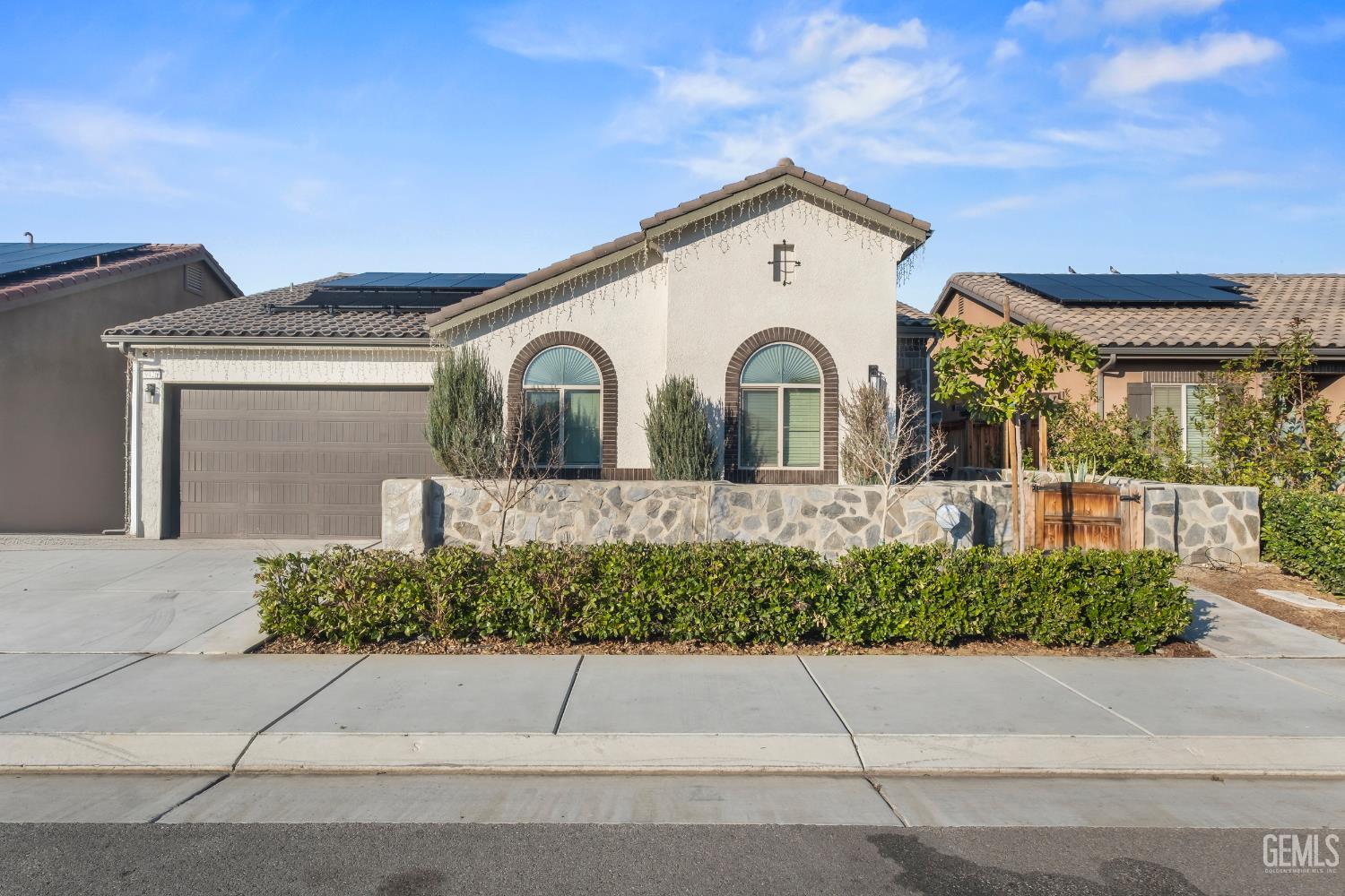 Undisclosed Address Shafter, CA 93263 - Photo 2 of 38 a front view of a house with a garden