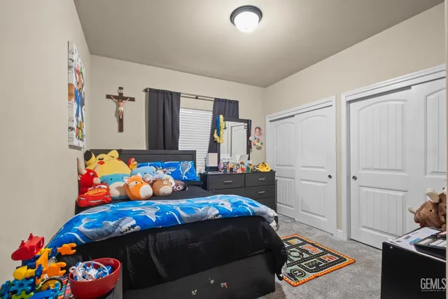 a bedroom with bed and wooden floor