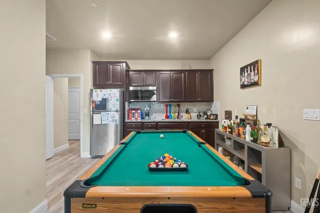 a room with microwave oven table and chairs
