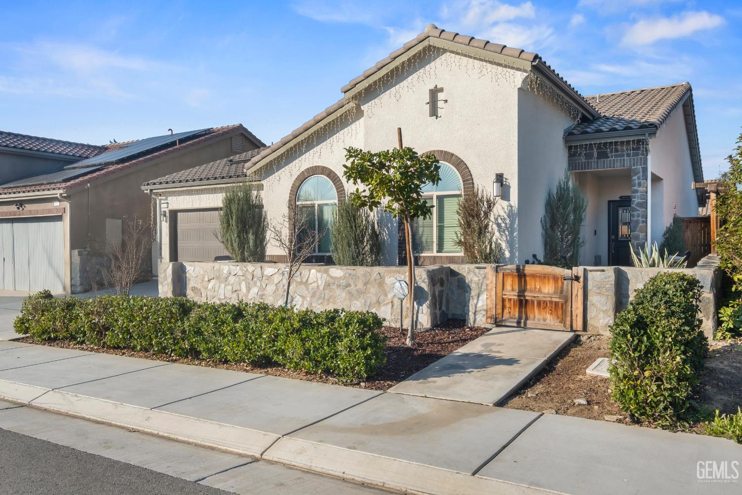 Undisclosed Address Shafter, CA 93263 - Photo 3 of 38 a front view of a house with a yard