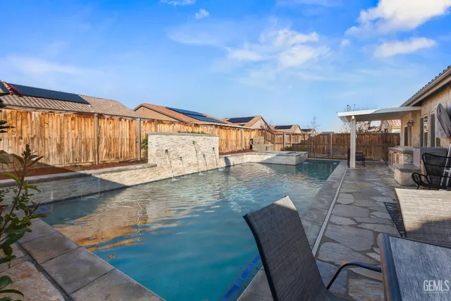 a view of swimming pool with outdoor seating
