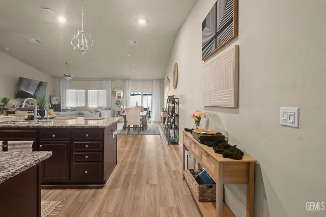 a kitchen with granite countertop a sink stove and cabinets