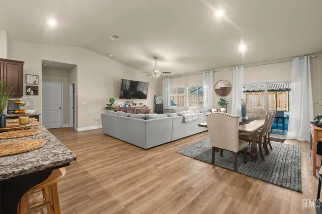 a living room with furniture and kitchen view