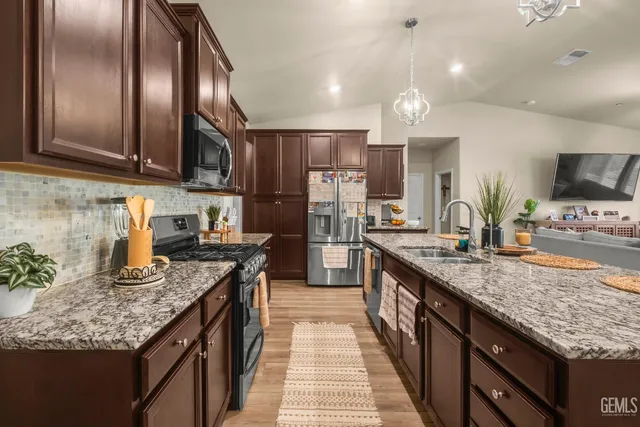 a kitchen with granite countertop stainless steel appliances and wooden cabinets