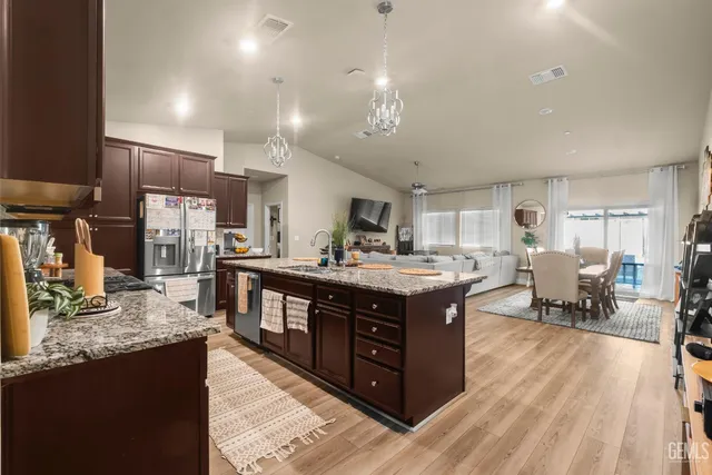 a large kitchen with stainless steel appliances granite countertop a large center island and a sink