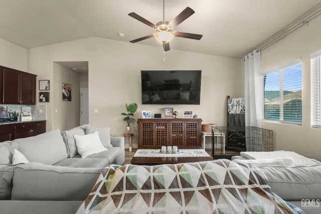 a living room with furniture a flat screen tv and a fireplace