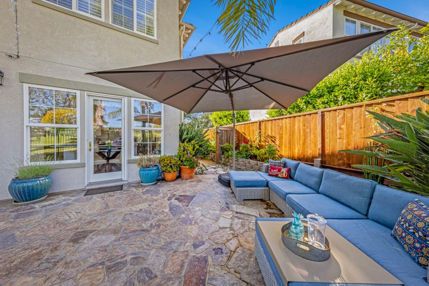 1937 St Andrews Circle Gilroy, CA 95020 - Photo 25 of 64 a view of a patio with couches and table under an umbrella