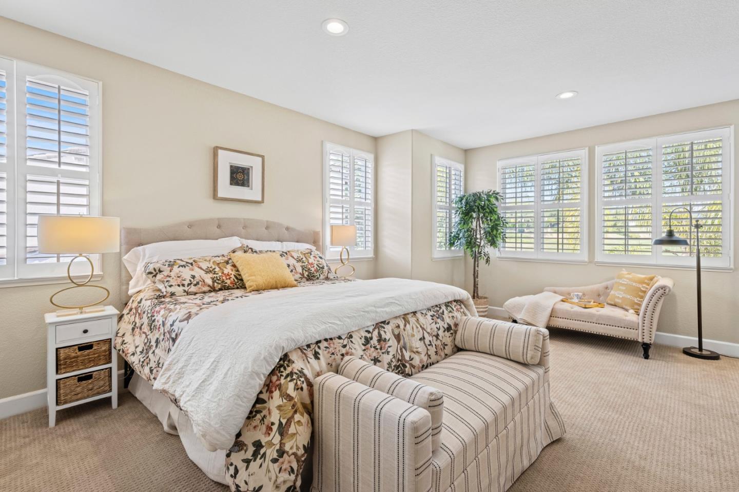 1937 St Andrews Circle Gilroy, CA 95020 - Photo 33 of 64 a spacious bedroom with a bed and a couch next to a window