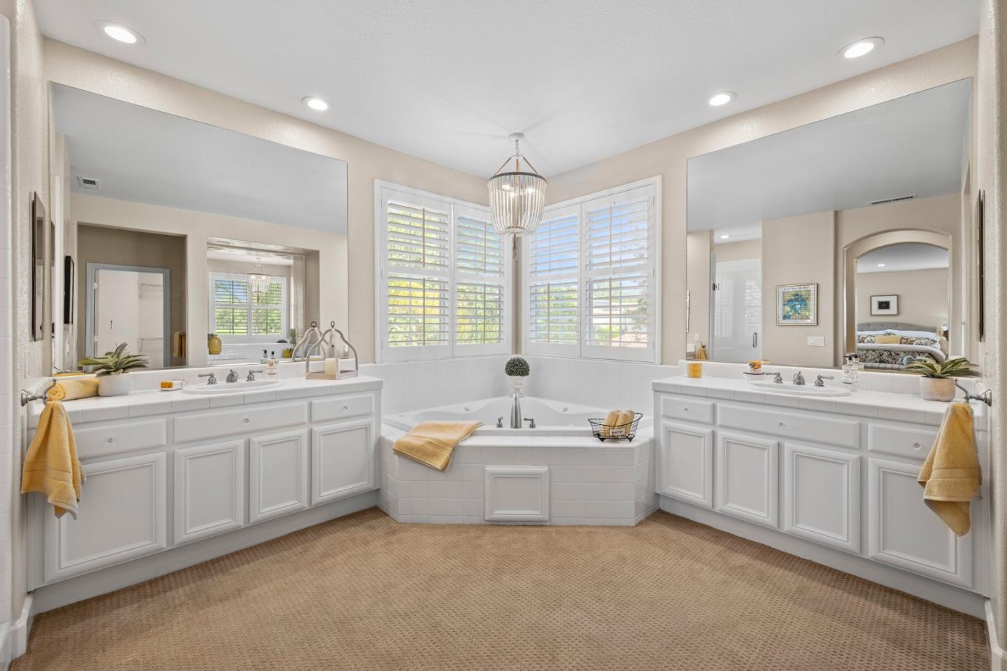 1937 St Andrews Circle Gilroy, CA 95020 - Photo 36 of 64 a bathroom with a double vanity sink bathtub large mirror and next to a window