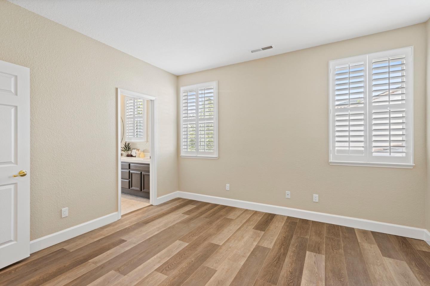 1937 St Andrews Circle Gilroy, CA 95020 - Photo 41 of 64 a view of a room with wooden floor and windows