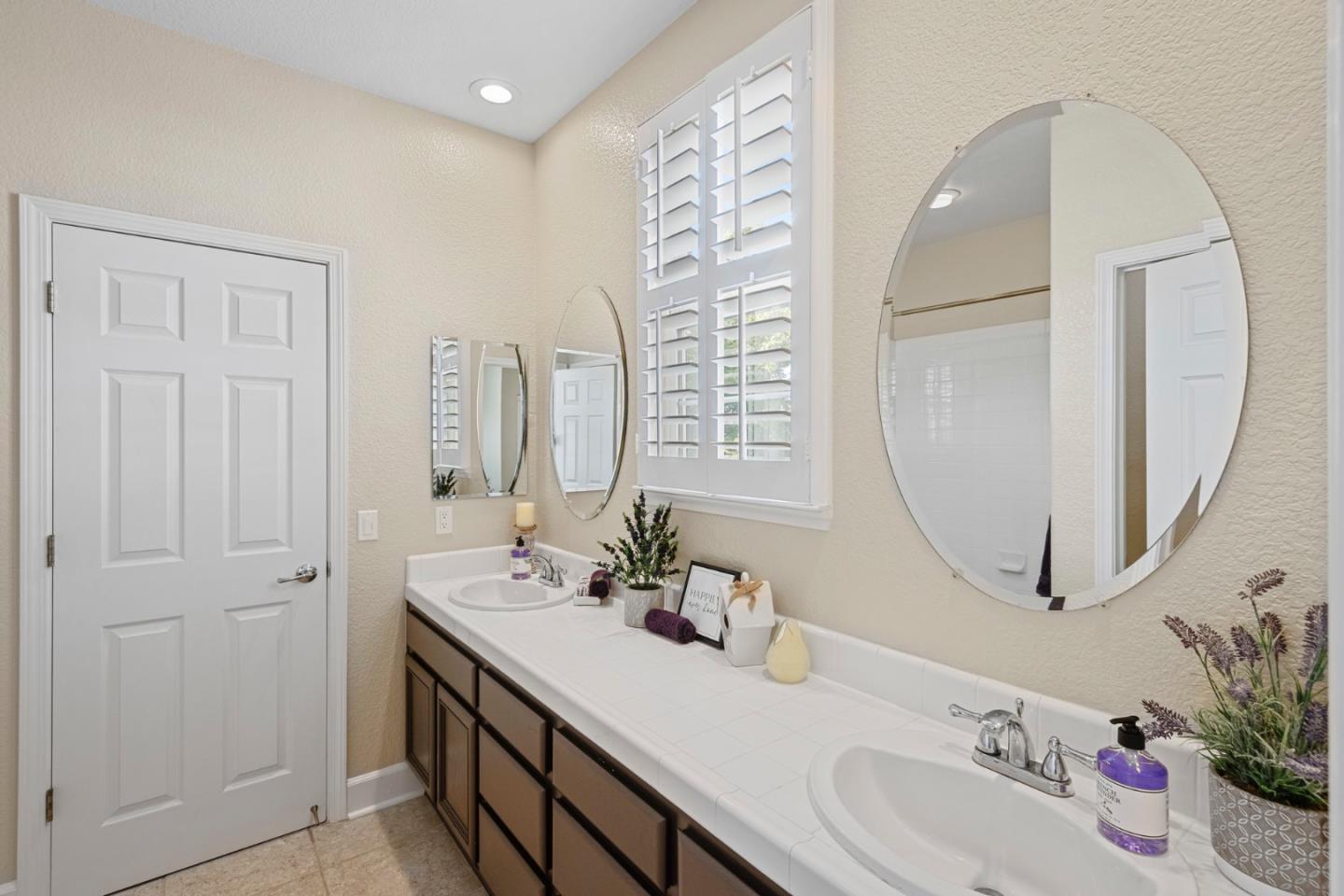 1937 St Andrews Circle Gilroy, CA 95020 - Photo 42 of 64 a bathroom with a double vanity sink and a mirror