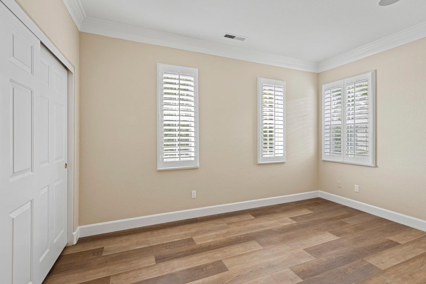 1937 St Andrews Circle Gilroy, CA 95020 - Photo 44 of 64 a view of an empty room with wooden floor and a window