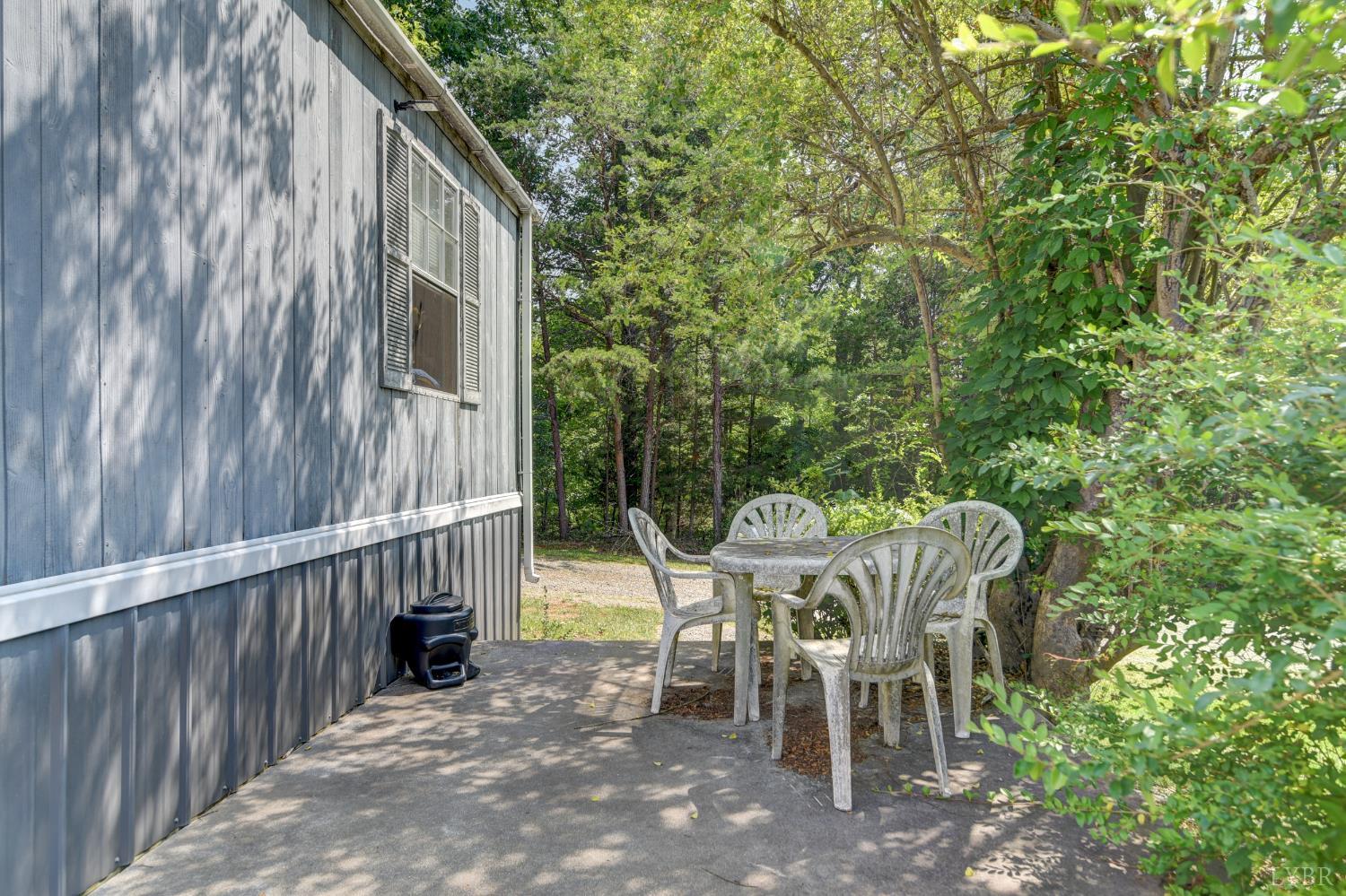3122 Buffalo Run Thaxton, VA 24174 - Photo 36 of 47 a view of a patio with table and chairs and floor to ceiling window