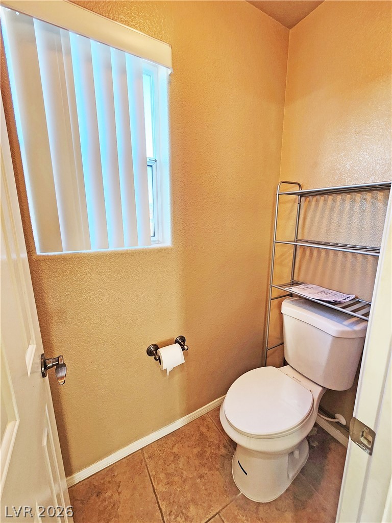 3680 Ravine Avenue Pahrump, NV 89048 - Photo 17 of 28 Bathroom featuring toilet, tile patterned floors, and baseboards