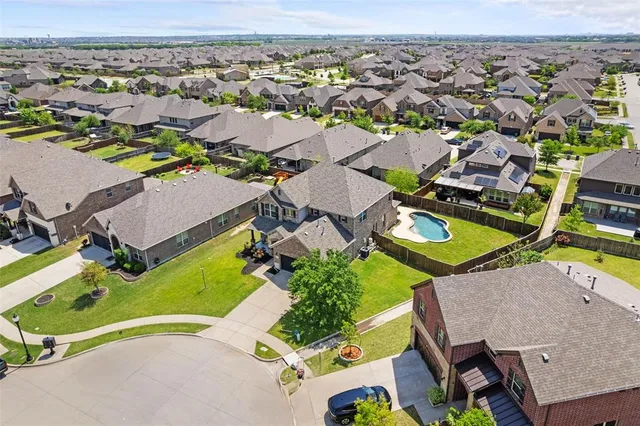 an aerial view of residential houses with outdoor space